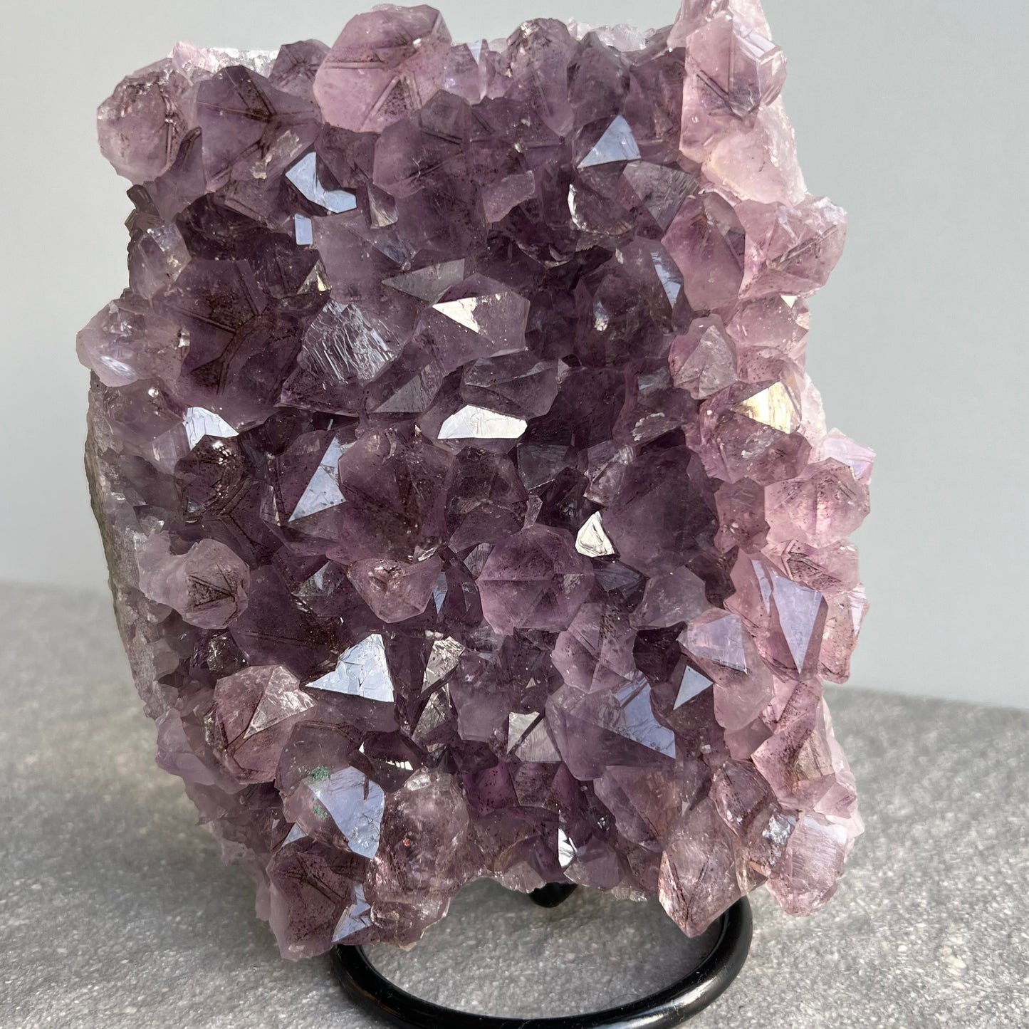 Wunderschöne dunkellila Amethyst Stufe auf schwarzem Metall-Ständer - viele große Kristalle - von vorne